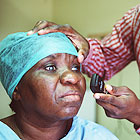 South Africa, Woman getting a check-up at the Sabona Centre